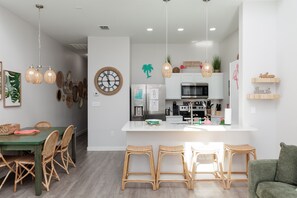 Dining table and breakfast bar with easy access to the gourmet kitchen