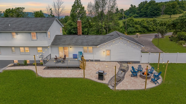 Relax in this spacious retreat with a lit patio, cozy fire pit, and serene views