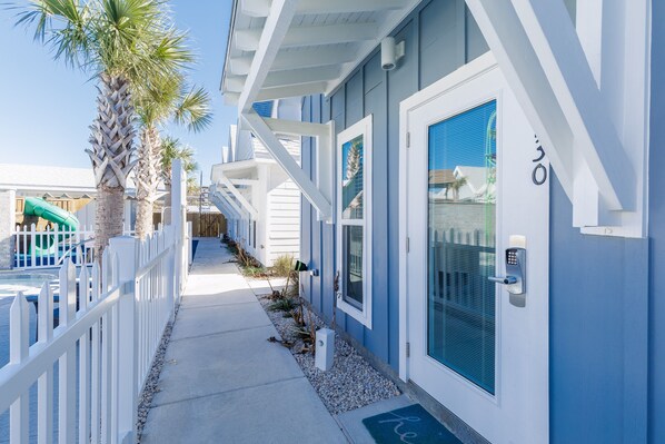 Front entryway opening up to playground / pool area