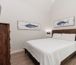 Master bedroom with clothing storage, king size bed, and back patio access