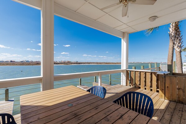 Relax on the downstairs balcony, complete with a picnic table and picturesque waterfront vistas