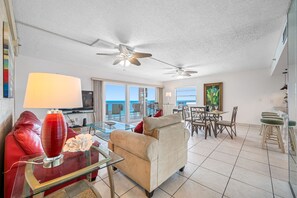 Living room area, looking towards dinner table and open air balcony.  