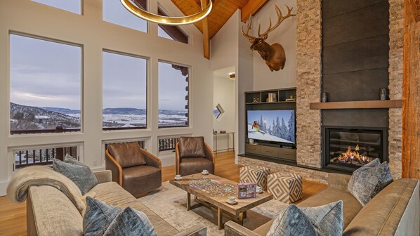 Spacious great room with TV, fireplace, and views!