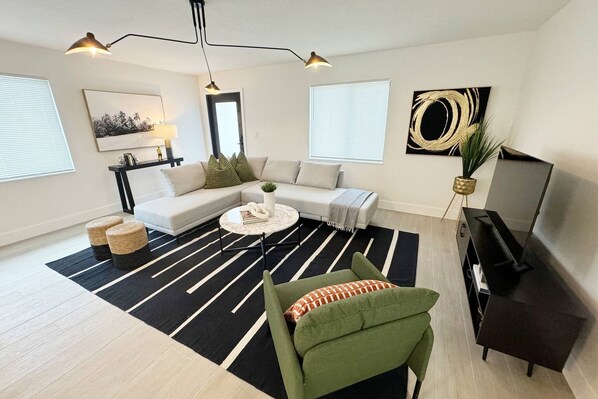 Stylish open concept living room with a Flat screen TV. 