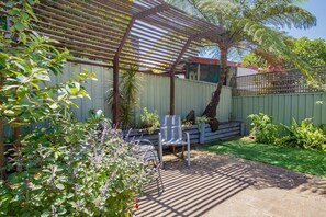 The quaint outdoor area provides a peaceful spot to read a book in the fresh air.
