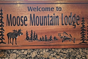 Moose Mtn Lodge welcome plaque above the front door