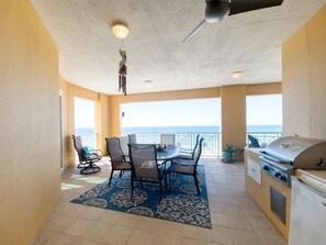 Massive covered patio with sprawling ocean views and a grill