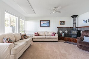 A comfortable living room with big windows and a big TV
