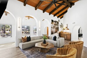 Living room with plush sectional, accent chairs, and ambient lighting