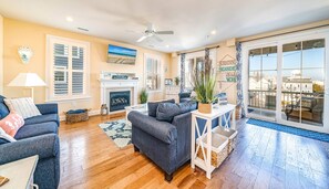 Bright and coastal living room with fireplace and balcony