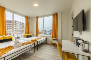 Bright and modern bedroom with sleek decor and a restful vibe.