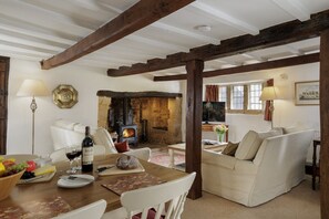 Sitting room with a wood burning stove, sumptuous seating and dining area