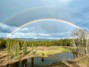 Double Rainbow over pond infront  of cabin