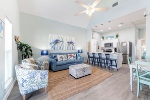 Open concept living area with queen size sleeper sofa and flat screen TV
