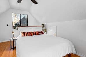 Loft bedroom with comfy bed and linens.