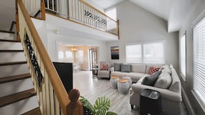 Open concept living area and stairs to second level