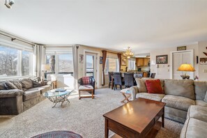Well-lit living and dining area with large windows offering scenic views.