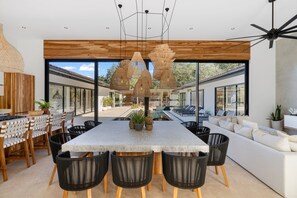 Large dinning room table with pool view