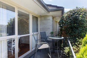 The balcony area has a cafe style round table and chairs, ideal for enjoying your morning coffee in the sun. 
