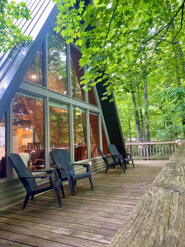 Front deck with 4 chairs and a grill