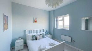 Drift into tranquility in our serene blue bedroom, a peaceful retreat for restful nights.