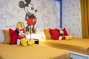 Mickey Mouse themed bedroom with a twin and full size beds