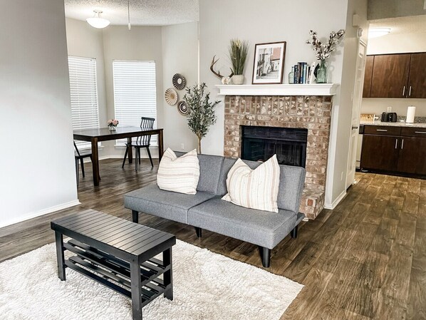 A bright living room features couch, fireplace and a TV for your comfort