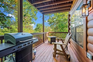 The back patio, located off the main level, features a grill and fire pit, providing guests with the perfect space for outdoor cooking and relaxation.