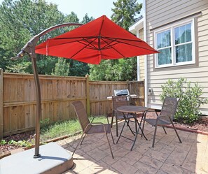 Back patio-Fenced in with seating, large umbrella and gas grill