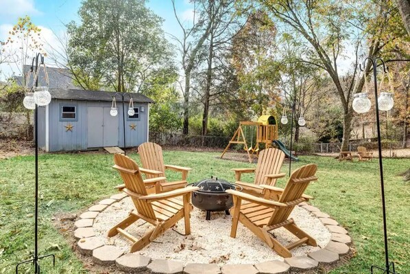 Large, gated backyard with firepit and play structure