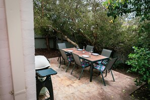 Outdoor dining area and gas BBQ. 