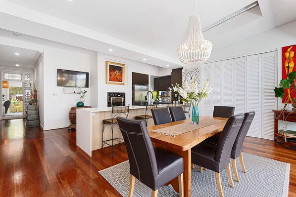 Gather around the elegant dining table, perfect for entertaining guests or enjoying family meals in this bright and airy space.