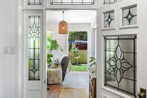 Enter a world of charm through this inviting entrance, adorned with beautiful stained-glass windows and a welcoming atmosphere.