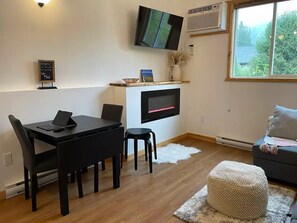 Flip-top table to accommodate 4 guests, with stools. Fireplace emits nice heat!