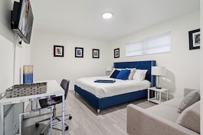 Bedroom # 4 - King Suite 2 | Blue Velvet King Bed | Work Space | Futon Sofa Bed for two| Walk-In Closet This king bedroom includes a walk-in closet, desk for remote working, en-suite bathroom with a tub/shower combo, and a futon