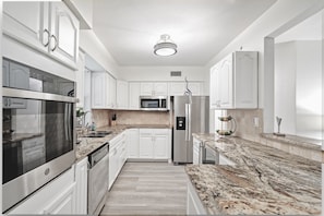Fully Stocked Kitchen – Cook & Dine with Ease! Our modern kitchen features a Keurig coffee maker, wall oven, cooktop, refrigerator, wine fridge, blender, air fryer, crockpot, and all the cookware & utensils you need.