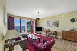 Living Area with Ocean Views, Flat Screen TV, Dining Area, and Private Balcony Access