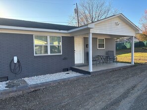 Level 2 Tesla EV Charger, Covered Porch, Patio Furniture, Privacy fencing behind