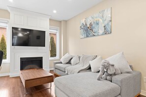 Family room - TV, fireplace, and sofa