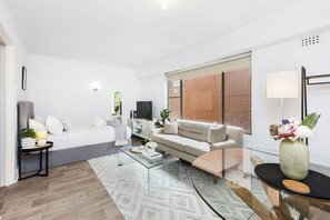 This seating area invites you to unwind after a long day, while the dining table is perfect for enjoying a meal or working from home, and a perfect bed for relaxation.