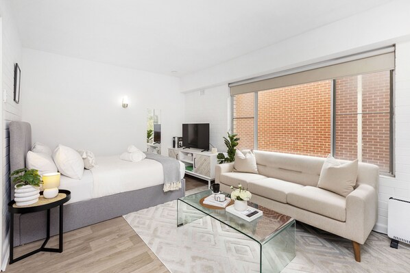 This inviting space offers a perfect blend of comfort and style. Unwind on the plush sofa, enjoy a meal at the dining table, or relax in the cozy bed.