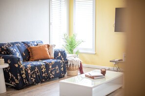 Relax and unwind in this cozy living space, bathed in natural light and filled with inviting textures.