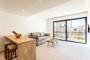 Relax in the sunlit living room where coziness and elegance harmonize