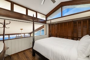 The loft bedroom is full of light with high ceilings