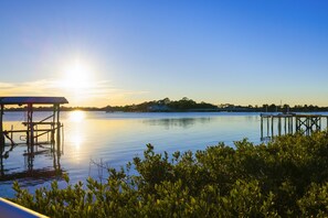 The sun setting over the Gulf from the front of the property