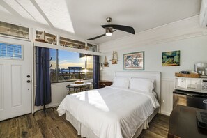 Queen sized bed with TV and large window