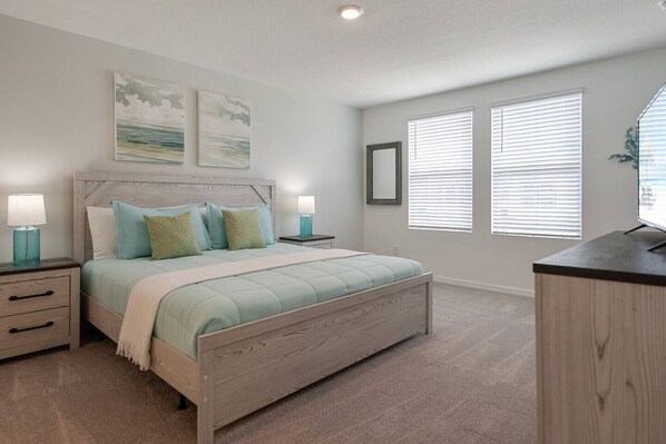 Master bedroom, king sized bed and ensuite bathroom with double vanity.