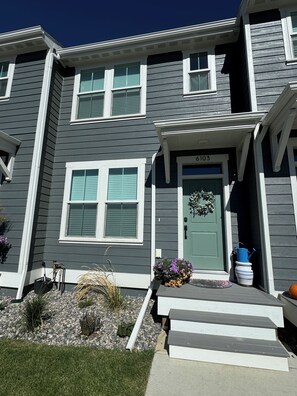 Front Entry into townhouse with small front yard and room to park.