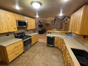 Kitchen.  Fully stocked with dishes, pots, pans and cooking utensils.