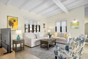 Our living area beckons with a plush sofa, a state-of-the-art TV, and an abundance of natural light. Your relaxation haven awaits."